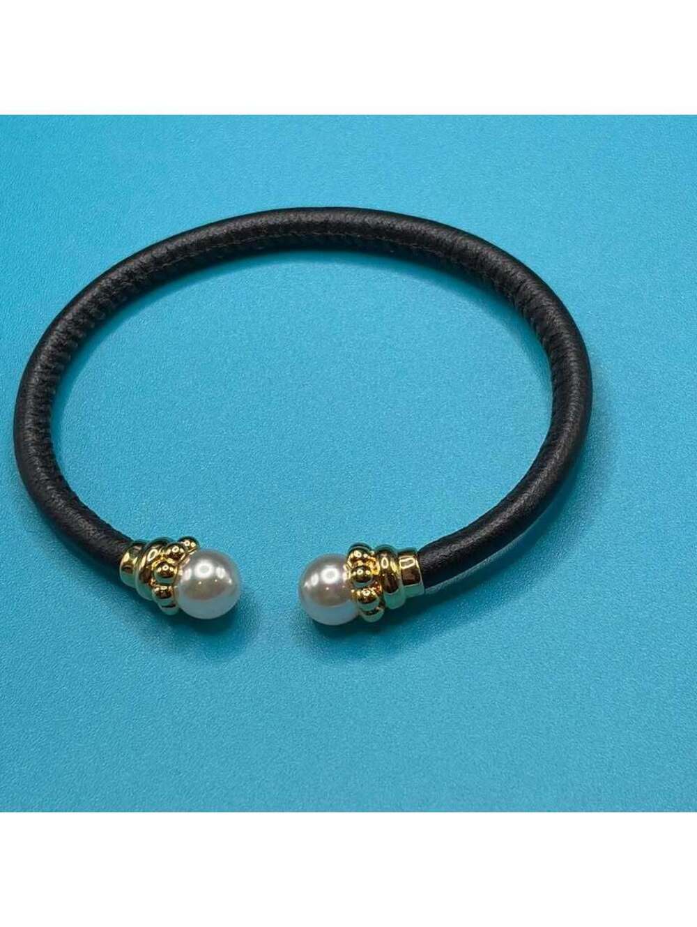 Black leather bracelet with two white pearls and gold accents #pearl #leather